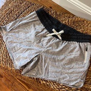 Vuori run shorts gray and white stripe with side zip pocket